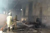 Keterangan Foto: Petugas Pemadam Saat Sedang Melakukan Pendinginan di area kebakaran pabrik oil pada Kamis,(6/4).