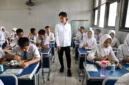 Students engage with a teacher in an interactive classroom session.