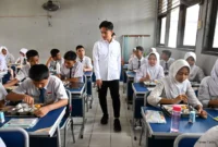 Students engage with a teacher in an interactive classroom session.